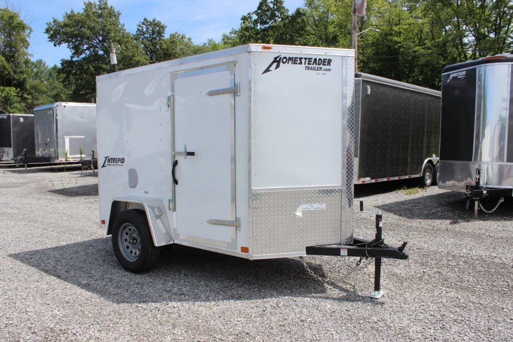 A white 5x8 Homesteader cargo trailer on our trailer dealership lot. 