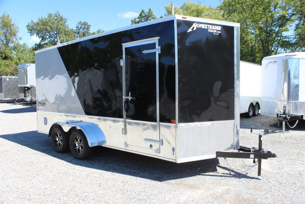 A black and silver Homesteader enclosed cargo trailer on our lot. 