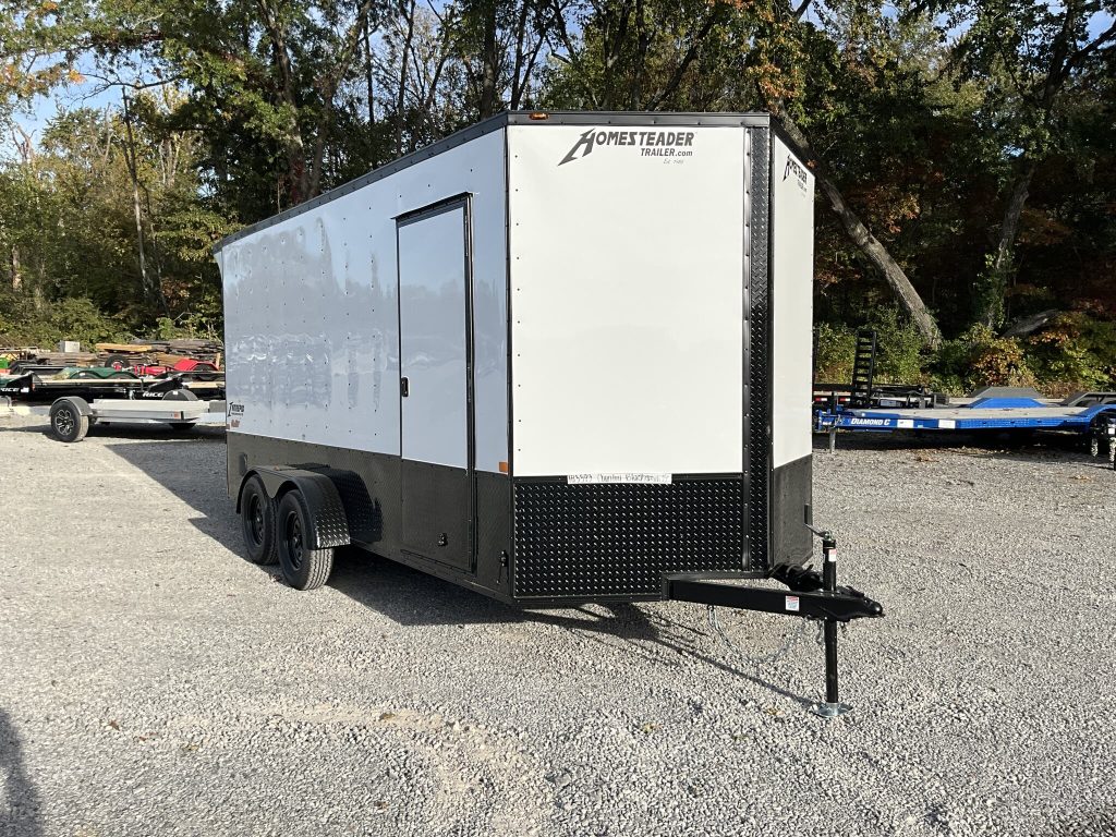 A white enclosed cargo trailer on the lot at Country Blacksmith Trailers. 